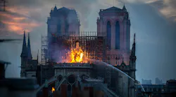 Paris firefighters battle smoke and flames as a massive blaze partially destroyed the Notre-Dame Cathedral on Monday.