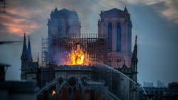 Paris firefighters battle smoke and flames as a massive blaze partially destroyed the Notre-Dame Cathedral on Monday.
