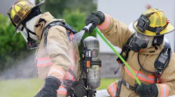 Orange County firefighters demonstrate the use of a decontamination kit to hose deadly carcinogens off their gear.