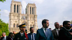 French Interior Minister Christophe Castaner (center) and French officials gather Thursday outside Notre Dame cathedral after a daylong tribute ceremony to honor the Paris firefighters who saved the 850-year-old cathedral from being destroyed by fire.