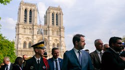 French Interior Minister Christophe Castaner (center) and French officials gather Thursday outside Notre Dame cathedral after a daylong tribute ceremony to honor the Paris firefighters who saved the 850-year-old cathedral from being destroyed by fire. French Interior Minister Christophe Castaner (center) and French officials gather Thursday outside Notre Dame cathedral after a daylong tribute ceremony to honor the Paris firefighters who saved the 850-year-old cathedral from being destroyed by fire.