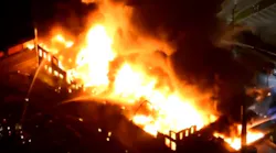 Philadelphia firefighters battled a four-alarm fire at a vacant warehouse in the Port Richmond neighborhood Sunday night.
