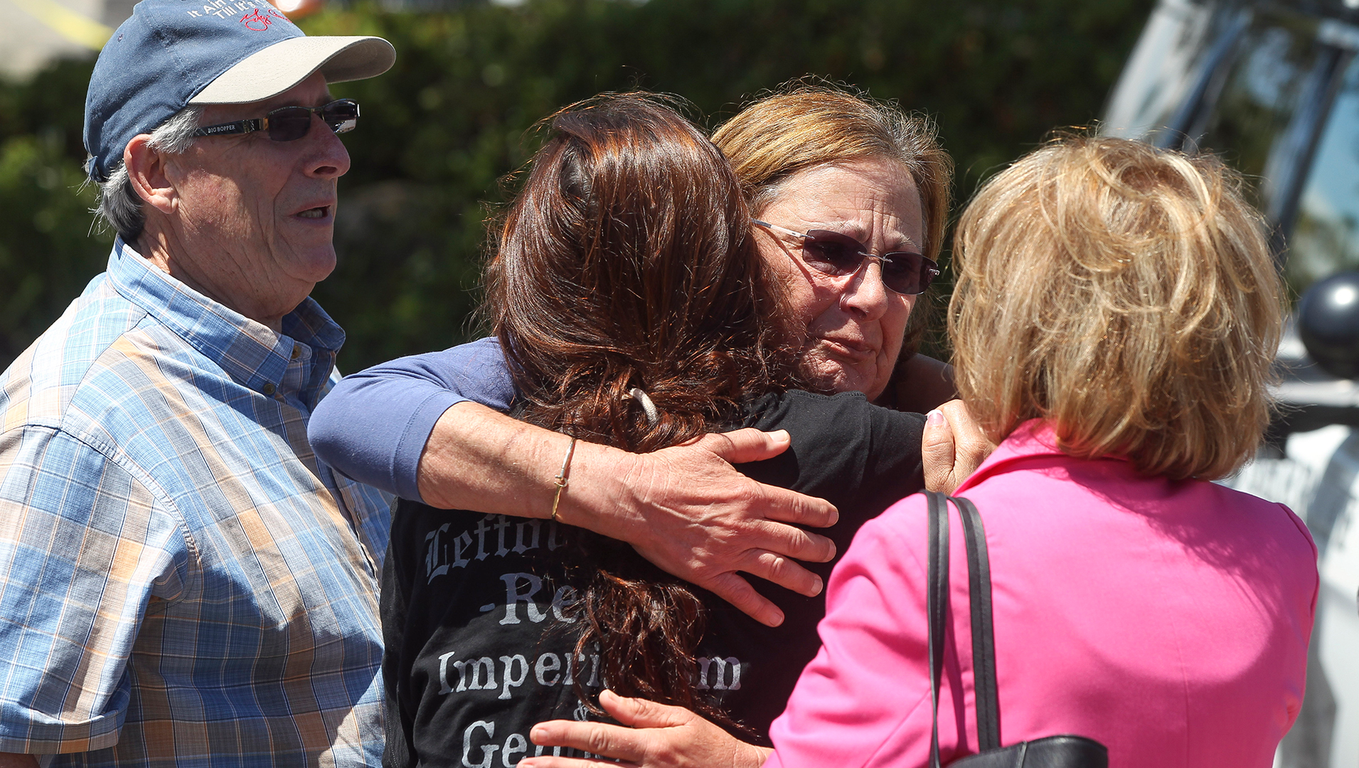Members of the Chabad synagogue in Poway, CA, hug Saturday following a shooting that killed one person and wounded three others.