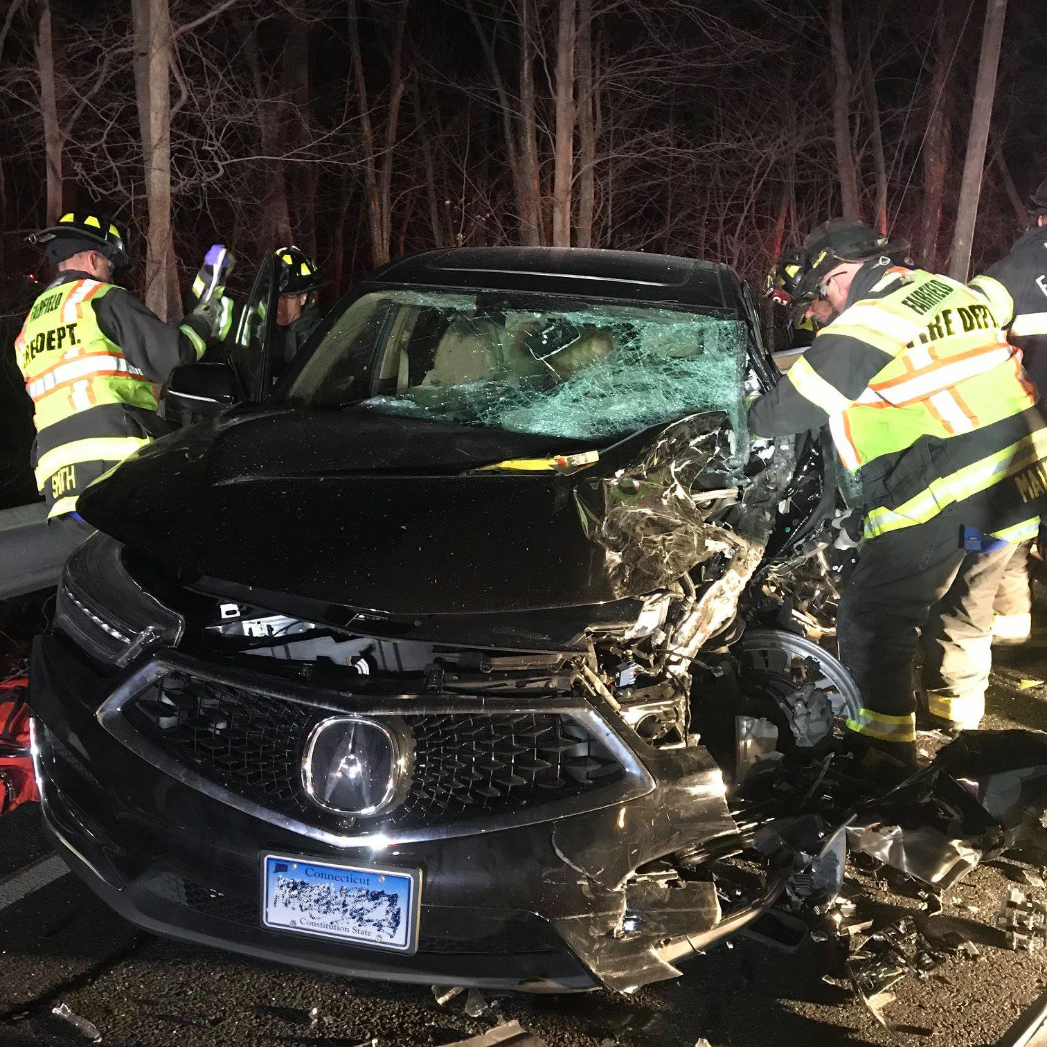 Fairfield, CT, firefighters rescued three people from an overturned pickup truck and an SUV following a head-on collision with the two vehicles Wednesday night.