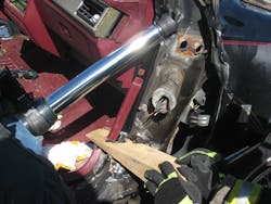 The hydraulic ram displaces the dashboard as the wedge is inserted in the relief cut to capture the space needed for victim removal.