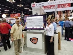 Dawn Dalldorf-Jackson, Streamlight Director of Sales, Industrial/Fire Divisions (right) presents Streamlight&rsquo;s donation check to NFFF Chief Ronald Siarnicki.