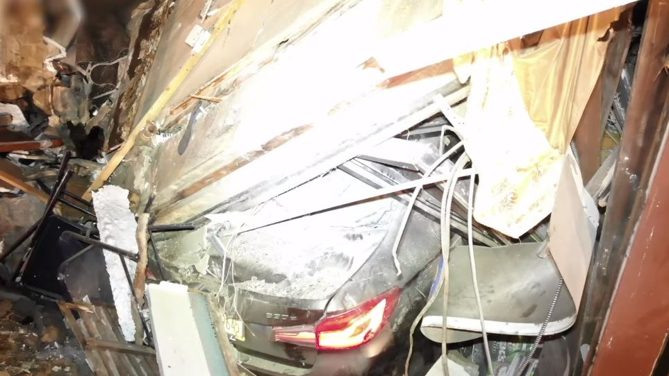 A building in Brooklyn partially collapsed Monday after a car crashed into it.