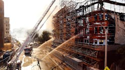 Los Angeles firefighters pour water on hot spots after a massive fire at an apartment complex construction site on Dec. 8, 2014. Los Angeles firefighters pour water on hot spots after a massive fire at an apartment complex construction site on Dec. 8, 2014.