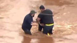 A bystander pulled a woman from fast-moving floodwaters in Oklahoma City, OK, on Tuesday. A bystander pulled a woman from fast-moving floodwaters in Oklahoma City, OK, on Tuesday.