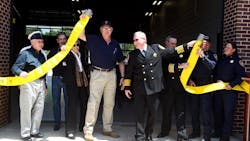 ESD No. 2 President Thomas Nanninga (left) and Sam Bass Fire Chief David Kieschnick, center, perform a fire hose uncoupling during the grand opening of the ESD No. 2 and Sam Bass Fire Department Fire Station No. 3. ESD No. 2 President Thomas Nanninga (left) and Sam Bass Fire Chief David Kieschnick, center, perform a fire hose uncoupling during the grand opening of the ESD No. 2 and Sam Bass Fire Department Fire Station No. 3.