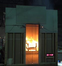 Still frames of the ISO 9705 Test Room burn tests for no flame retardant (NFR, shown here), organophosphate flame retardant (OPFR), reactive flame retardant (RFR), and no flame retardant with barrier textile (BNFR) chairs at 14 minutes from ignition. Still frames of the ISO 9705 Test Room burn tests for no flame retardant (NFR, shown here), organophosphate flame retardant (OPFR), reactive flame retardant (RFR), and no flame retardant with barrier textile (BNFR) chairs at 14 minutes from ignition.