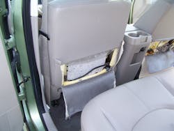 The lower rear upholstery of the seat with the seatbag is gently cut away to expose the thin-gauge wire pair that would normally fire the airbag inflator unit itself in a crash. The lower rear upholstery of the seat with the seatbag is gently cut away to expose the thin-gauge wire pair that would normally fire the airbag inflator unit itself in a crash.