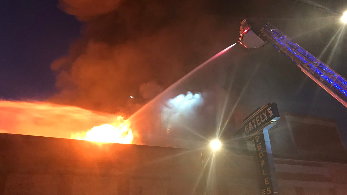 A three-alarm fire collapsed the roof and gutted the former Gately's Peoples Store early Friday in Chicago's Roseland neighborhood.