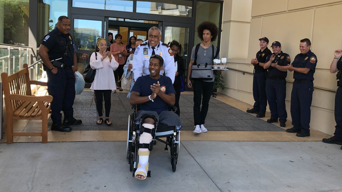 Atlanta Fire Sgt. Darrow Harden is greeted by his fellow firefighters as he leaves the Shepherd Center, where he has been for more than month following a May 12 on-duty crash at the scene of another accident.
