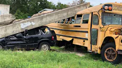 A concrete beam sits atop a school bus in Disaster City, College Station, Texas.