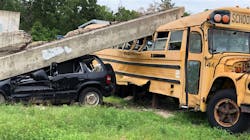 A concrete beam sits atop a school bus in Disaster City, College Station, Texas. A concrete beam sits atop a school bus in Disaster City, College Station, Texas.