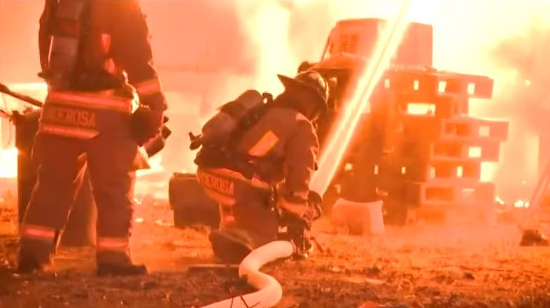 Two Harris County firefighters were hurt rescuing an elderly disabled man who was inside a burning home Thursday night.