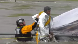 A Houston firefighter helps rescue a man Monday who was caught in swift-moving waters under a bridge and initially refused help from crews. A Houston firefighter helps rescue a man Monday who was caught in swift-moving waters under a bridge and initially refused help from crews.