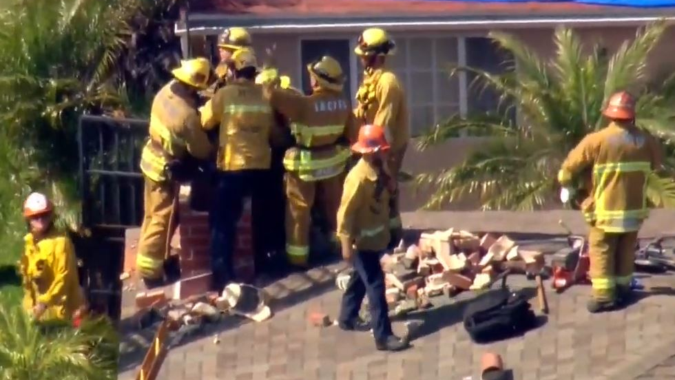 Los Angeles County firefighters rescued a teenager who was trapped in a two-story apartment complex's chimney Wednesday in Inglewood.