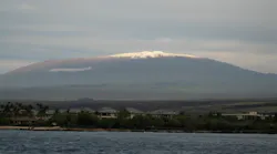 Hawaii County firefighters rescued a man who broke his leg while trying to take photos atop Mauna Kea on Monday night.