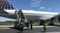 Firefighters help passengers disembark from a United Airlines passenger jet that skidded off the runway Saturday at Newark Liberty International Airport.