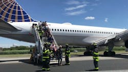 Firefighters help passengers disembark from a United Airlines passenger jet that skidded off the runway Saturday at Newark Liberty International Airport.