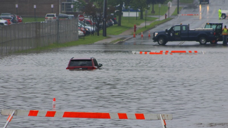 Oswego, NY, firefighters rescued at least one person who was trapped in a Jeep along a flooded water.