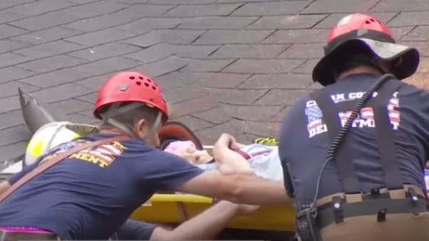 Firefighters from several departments rescued a 90-year-old Stanton, KY, woman Monday after a mudslide knocked her house off its foundation.