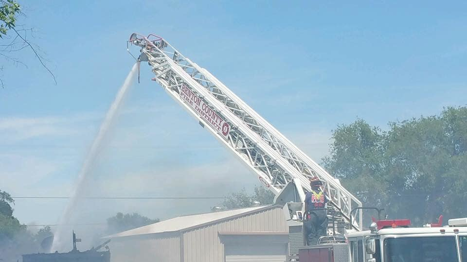Firefighters from Benton County, WA, and several other fire departments needed to use a backhoe to knock down the roof of a burning house in order to extinguish the flames Sunday.