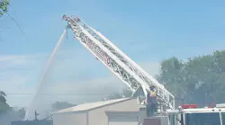 Firefighters from Benton County, WA, and several other fire departments needed to use a backhoe to knock down the roof of a burning house in order to extinguish the flames Sunday.