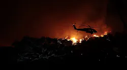 A helicopter battles the Woolsey fire in the hills above Pepperdine University in Malibu, CA, on Nov. 9, 2018.