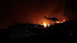A helicopter battles the Woolsey fire in the hills above Pepperdine University in Malibu, CA, on Nov. 9, 2018.