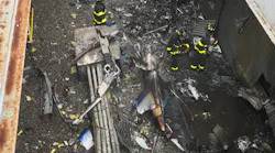 FDNY firefighters examine the site of a helicopter crash atop a Manhattan building Monday.