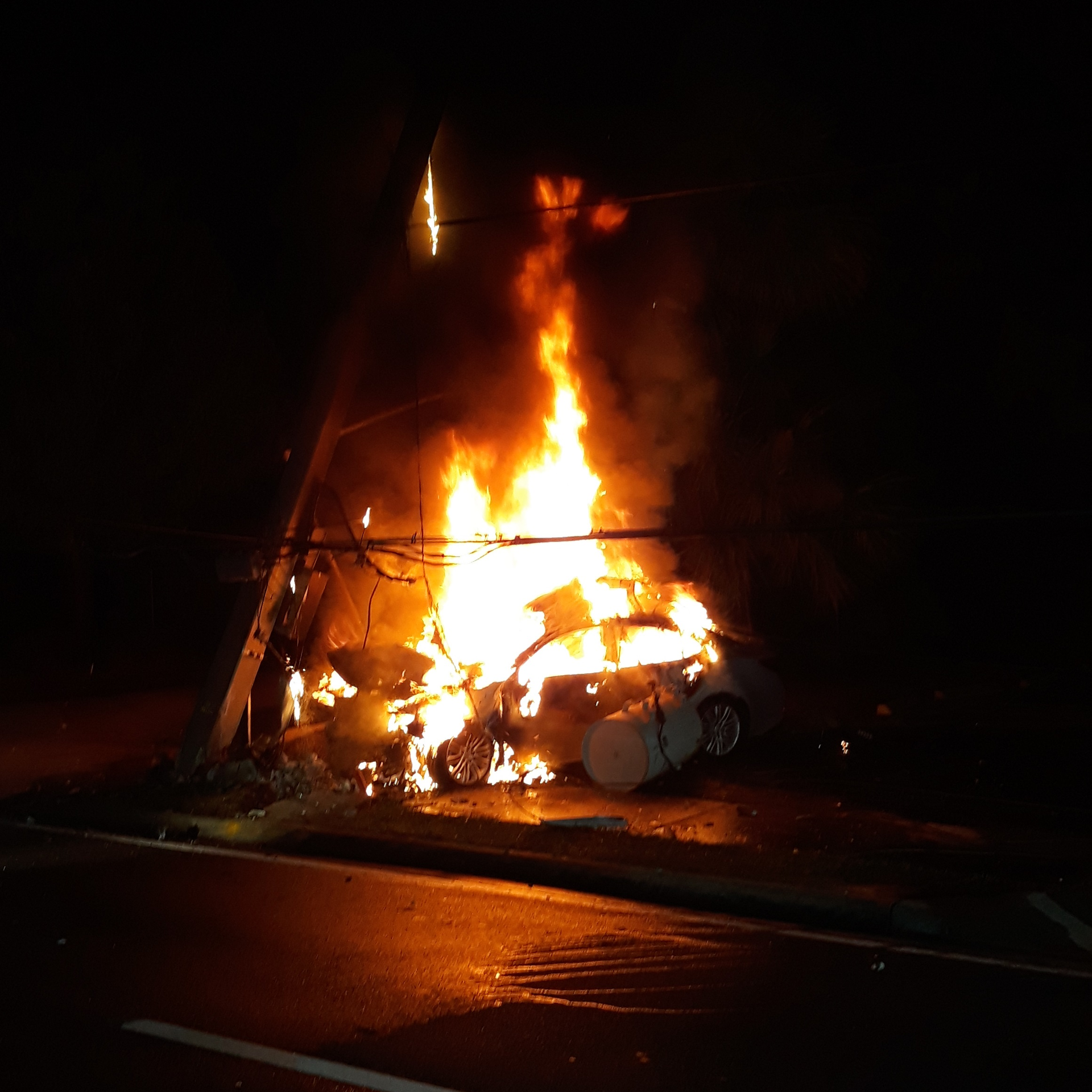 Ocala, FL, firefighters helped a trapped driver escape a burning car that caught fire after hitting a cement power pole early Thursday.