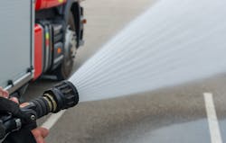 A fog nozzle would be best to attack a fire in close proximity to crews because it will hit a larger surface area with less effort. A fog nozzle would be best to attack a fire in close proximity to crews because it will hit a larger surface area with less effort.