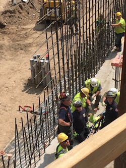 Minneapolis firefighters used an aerial device and stretcher to rescue a worker from below ground level at a downtown Minneapolis construction site Monday. Minneapolis firefighters used an aerial device and stretcher to rescue a worker from below ground level at a downtown Minneapolis construction site Monday.