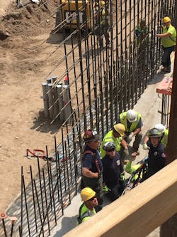 Minneapolis firefighters used an aerial device and stretcher to rescue a worker from below ground level at a downtown Minneapolis construction site Monday.