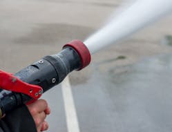 A smooth bore nozzle is best to tackle flames at a distance simply because it will make it possible for me to reach the fire without exposing crews to heat.