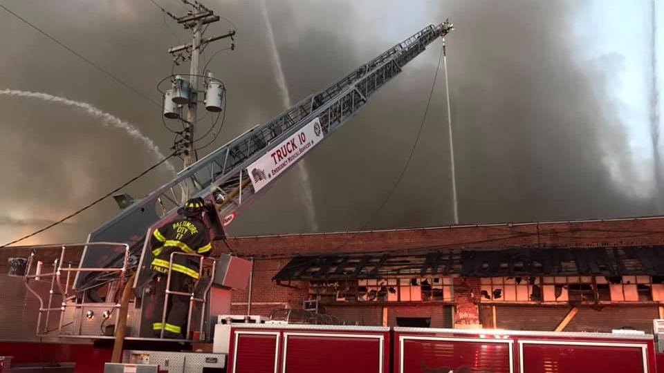More than 60 Baltimore City firefighters battled a four-alarm warehouse fire Monday.