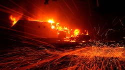 Embers blow in the wind as the Camp Fire burns a KFC restaurant in 2018 in Paradise, CA. Embers blow in the wind as the Camp Fire burns a KFC restaurant in 2018 in Paradise, CA.