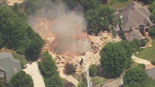 An explosion from a four-alarm fire leveled a home at Charlotte, NC, country club Tuesday, critically at least one person.