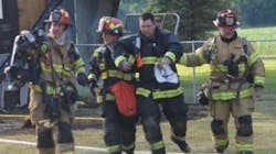 Crews help a firefighter who became overheated and dropped to his knees while battling a detached garage fire Sunday in Clark County, OH. Crews help a firefighter who became overheated and dropped to his knees while battling a detached garage fire Sunday in Clark County, OH.