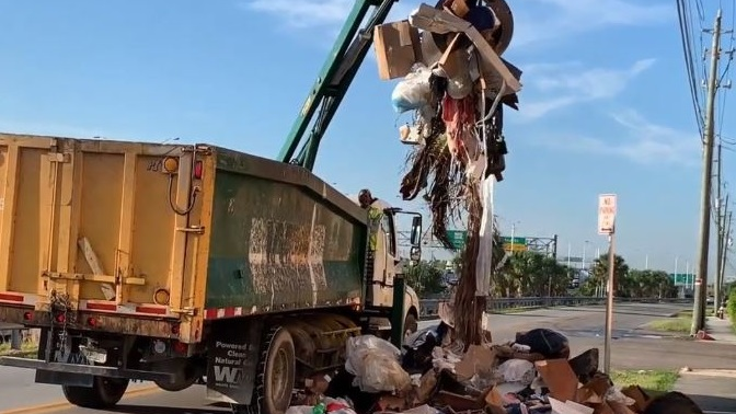 Hialeah, FL, firefighters searched through piles of trash for a possible trapped person after a worker heard a strange noise from the back of a garbage truck Friday.
