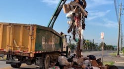 Hialeah, FL, firefighters searched through piles of trash for a possible trapped person after a worker heard a strange noise from the back of a garbage truck Friday. Hialeah, FL, firefighters searched through piles of trash for a possible trapped person after a worker heard a strange noise from the back of a garbage truck Friday.