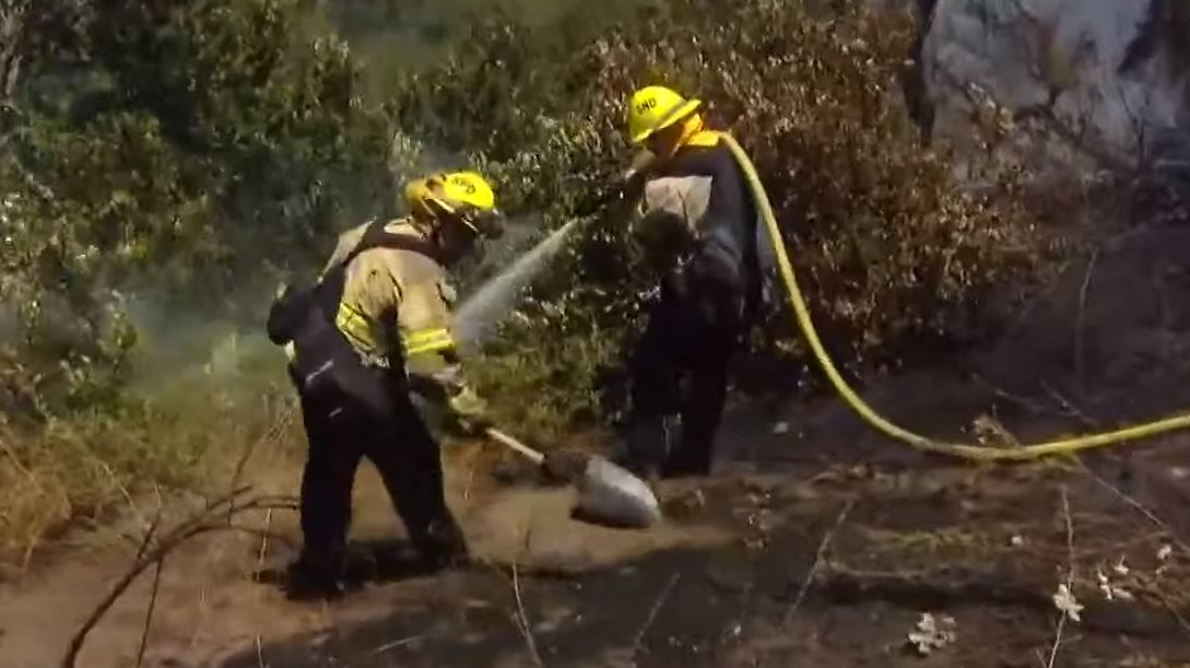 Firefighters from four departments battled a one-acre brush fire Tuesday in San Diego's Sabre Springs community.
