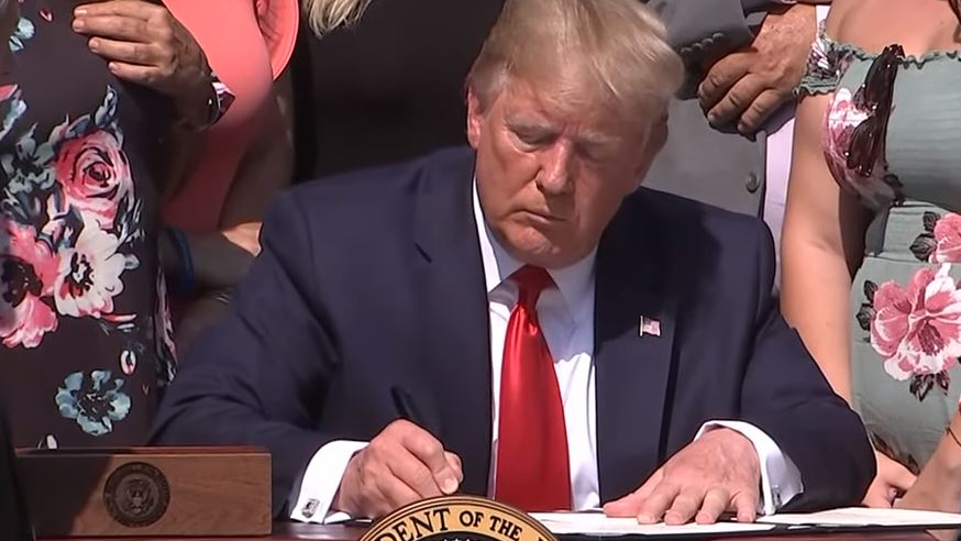 President Donald Trump signs the &ldquo;Never Forget the Heroes: James Zadroga, Ray Pfeifer and Luis Alvarez Permanent Authorization of the September 11th Victim Compensation Fund Act' into law Monday in the White House Rose Garden.