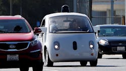 A Google self-driving car travels eastbound on San Antonio Road in Mountain View, CA.