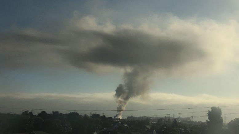 A plume of smoke can be seen from miles away after a fire broke out at a maintenance facility at San Francisco International Airport on Wednesday, July 31, 2019.