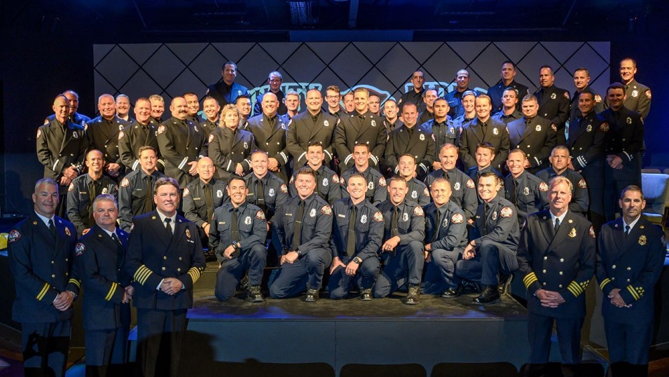 The 17 newest members of the Sonoma County, CA, Fire District, kneeling in the foreground, pose with their veteran colleagues during their graduation ceremony on June 29, 2019.