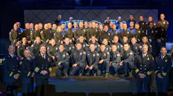 The 17 newest members of the Sonoma County, CA, Fire District, kneeling in the foreground, pose with their veteran colleagues during their graduation ceremony on June 29, 2019.
